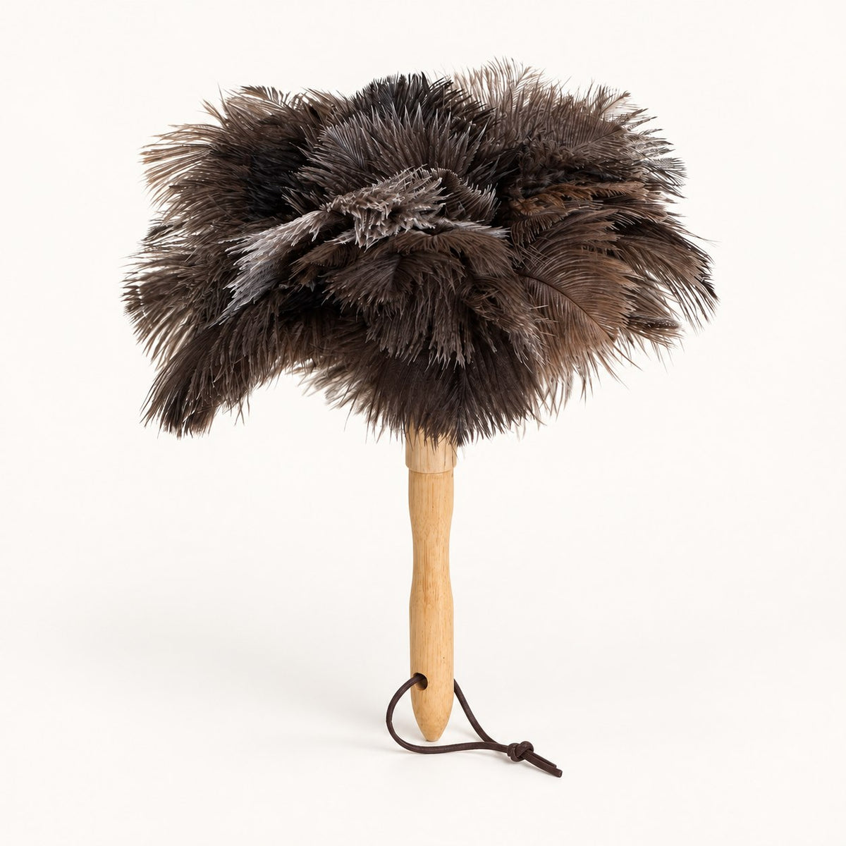Luvamira Classic Handheld ostrich feather duster standing upright on a warm off-white background.