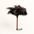 Luvamira Essential Handheld ostrich feather duster standing upright on a warm off-white background.