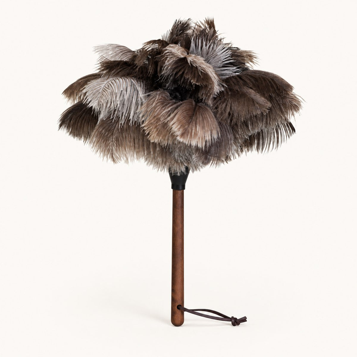 Luvamira Select Handheld ostrich feather duster standing upright on a warm off-white background.