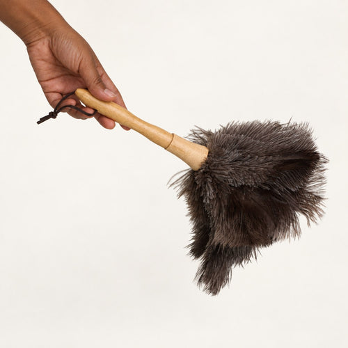 Luvamira Classic Handheld ostrich feather duster held horizontally to show its compact size.