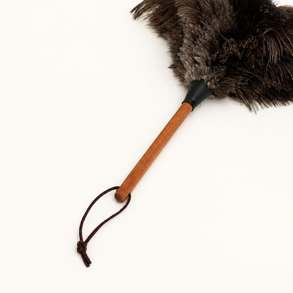 Walnut wood handle and leather hanging loop detail on the Luvamira Essential Handheld duster.