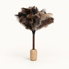 Luvamira natural wood stand holding a dark-handle feather duster