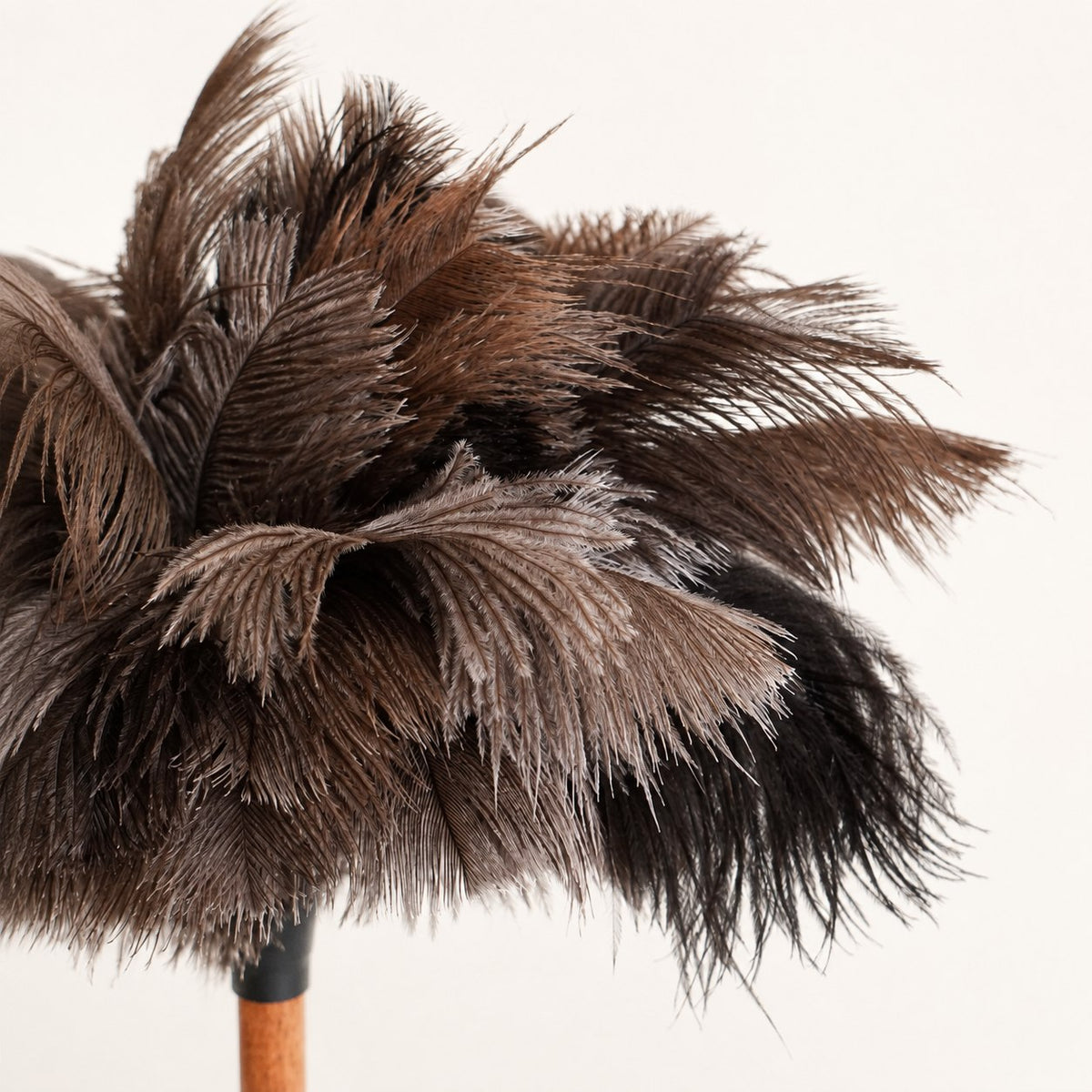 Side profile showing the natural feather layers of the Luvamira Essential Handheld ostrich feather duster.